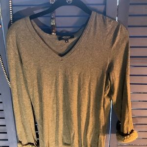 Karen Kane Grey casual woman’s top with fur sleeve cuffs.